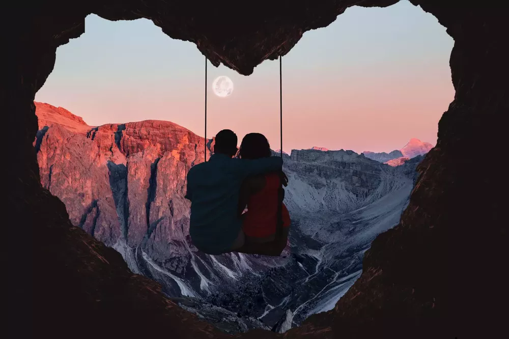 couple-on-swing-contemplating-the-mountains-in-a-romantic-view-with-heart-shape--1126081334-d0f421f4a81d4921ab0232ea6bf8e021